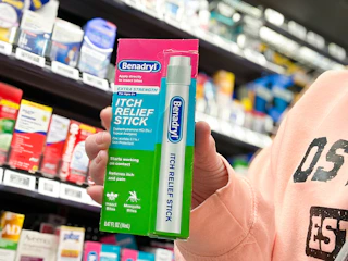 woman holding benadryl stick in walmart aisle