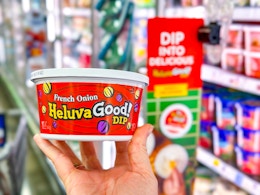 hand holding a tub of heluva good dip