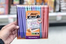 a hand holding a pack of pastel mechanical pencils