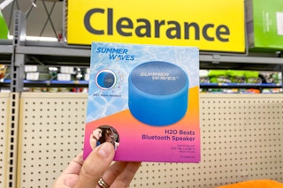 hand holding summer waves bluetooth speaker in front of clearance sign at walmart