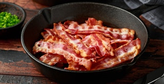 a skillet of cooked bacon