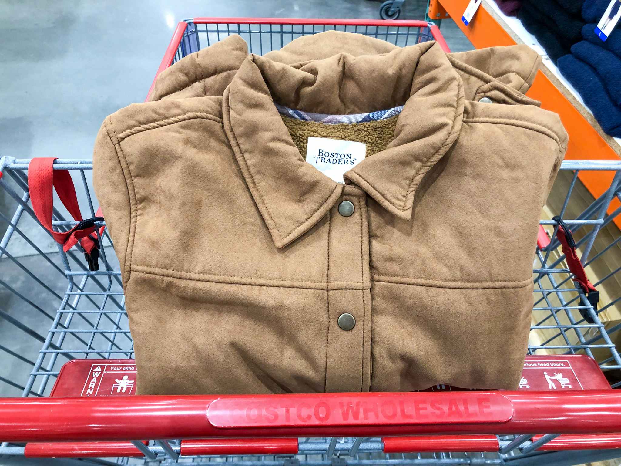 brown jacket in a costco cart