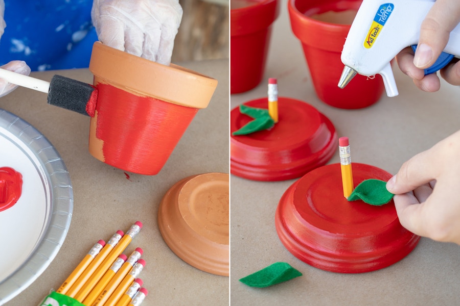 Person painting and gluing a felt leaf and pencil piece to make the pots resemble apples.