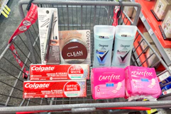 covergirl makeup, colgate toothpaste, degree deodorant, and carefree liners in a cart