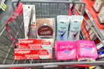 covergirl makeup, colgate toothpaste, degree deodorant, and carefree liners in a cart