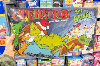 hand holding operation the grinch game in walmart aisle