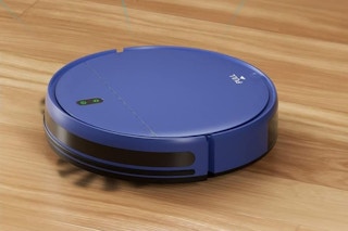 a blue robot vacuum on hardwood floor