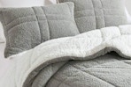 Lifestyle image of the Madison Park Comforter Set from Home Depot (in the color grey w/ reverse white Sherpa)