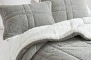 Lifestyle image of the Madison Park Comforter Set from Home Depot (in the color grey w/ reverse white Sherpa)