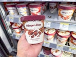 hand holding haagen dazs ice cream in walgreens