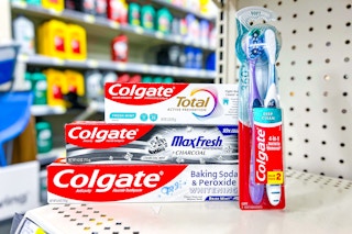 colgate toothpaste and toothbrushes stacked together on a store shelf