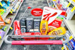 colgate toothpaste, axe body wash, nivea body wash, maybelline makeup, garnier shampoo, and special k cereal in a cart