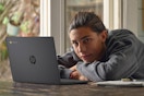 young man with a laptop in front of him