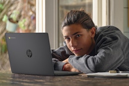 young man with a laptop in front of him
