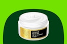 A jar of white snail mucin moisturizing cream all in one, missing the lid, for skin renewal.