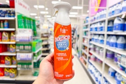 hand holding bounce instant static spray in a target aisle