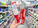 hand holding colgate oral care in walgreens