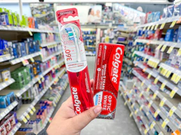 hand holding colgate oral care in walgreens