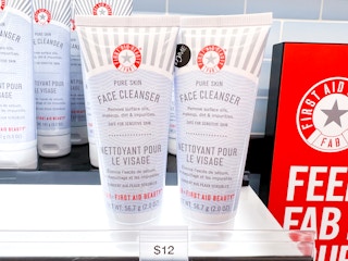 Two bottles of First Aid Beauty pure skin face cleanser on a shelf inside Sephora.