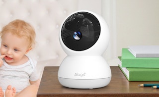 a security camera on a desk next to a baby