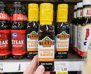 hand holding a bottle of texas roadhouse steak sauce at kroger
