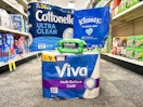 cottonelle, viva, and kleenex products on the floor in an aisle
