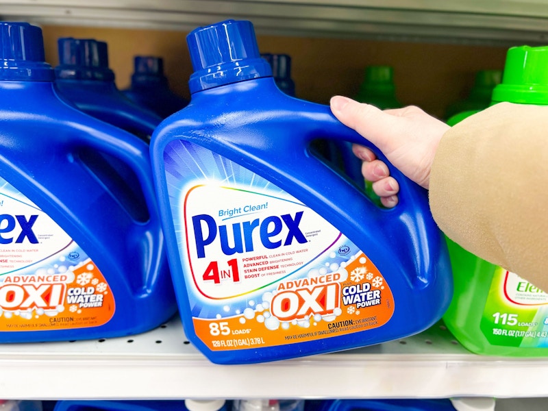 person grabbing a bottle of purex detergent off a shelf