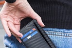 a rfid wallet being pulled out of a pocket