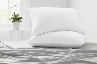 two queen pillows in white bedding