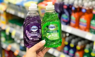 hand holding two bottles of Dawn liquid dish soap