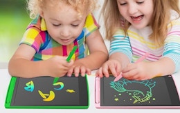 two kids drawing on two writing tablets 