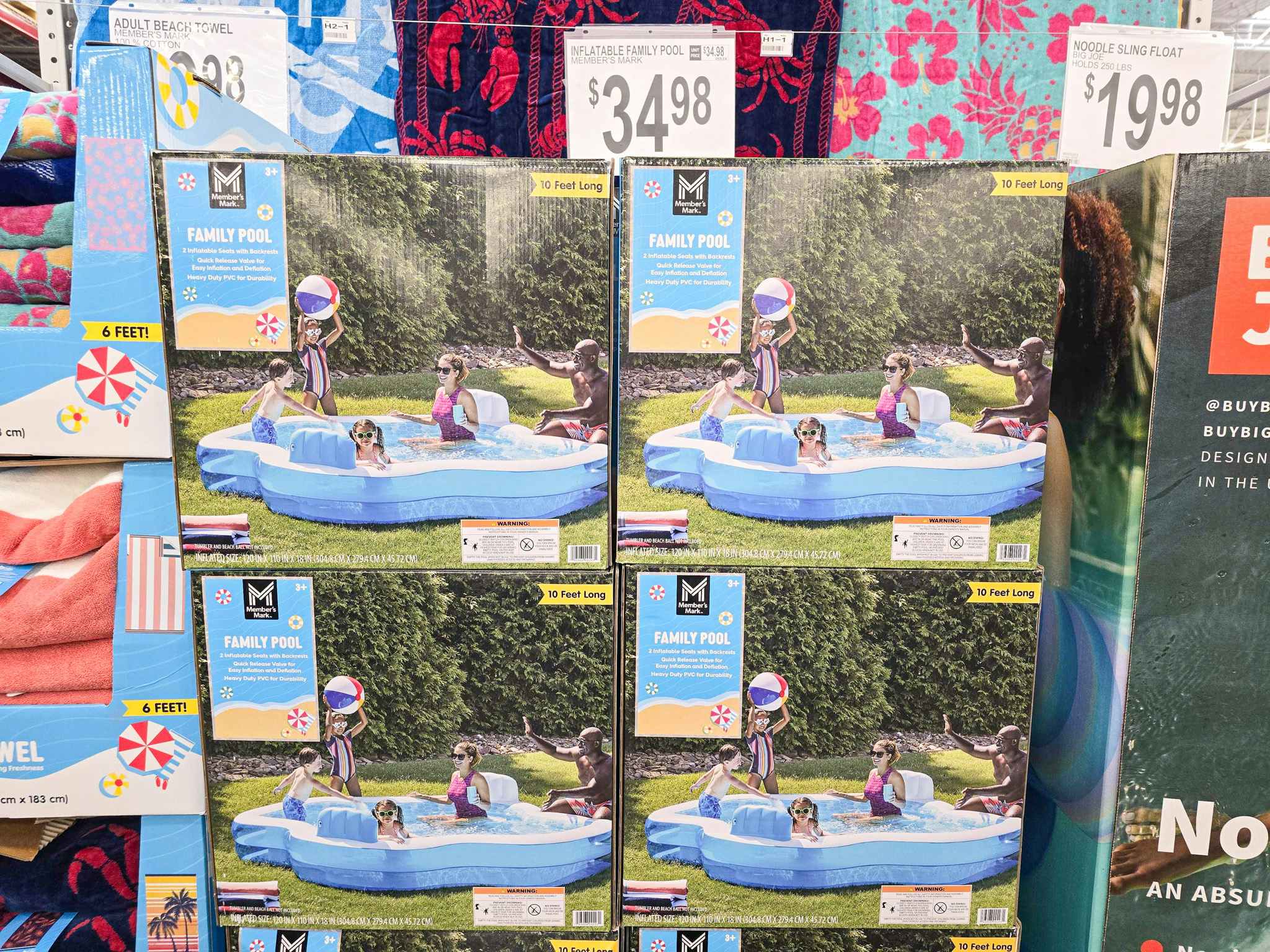 boxes stacked up of inflatable family pools with a $34.98 price sign