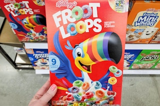 hand holding a box of kelloggs cereal at kroger