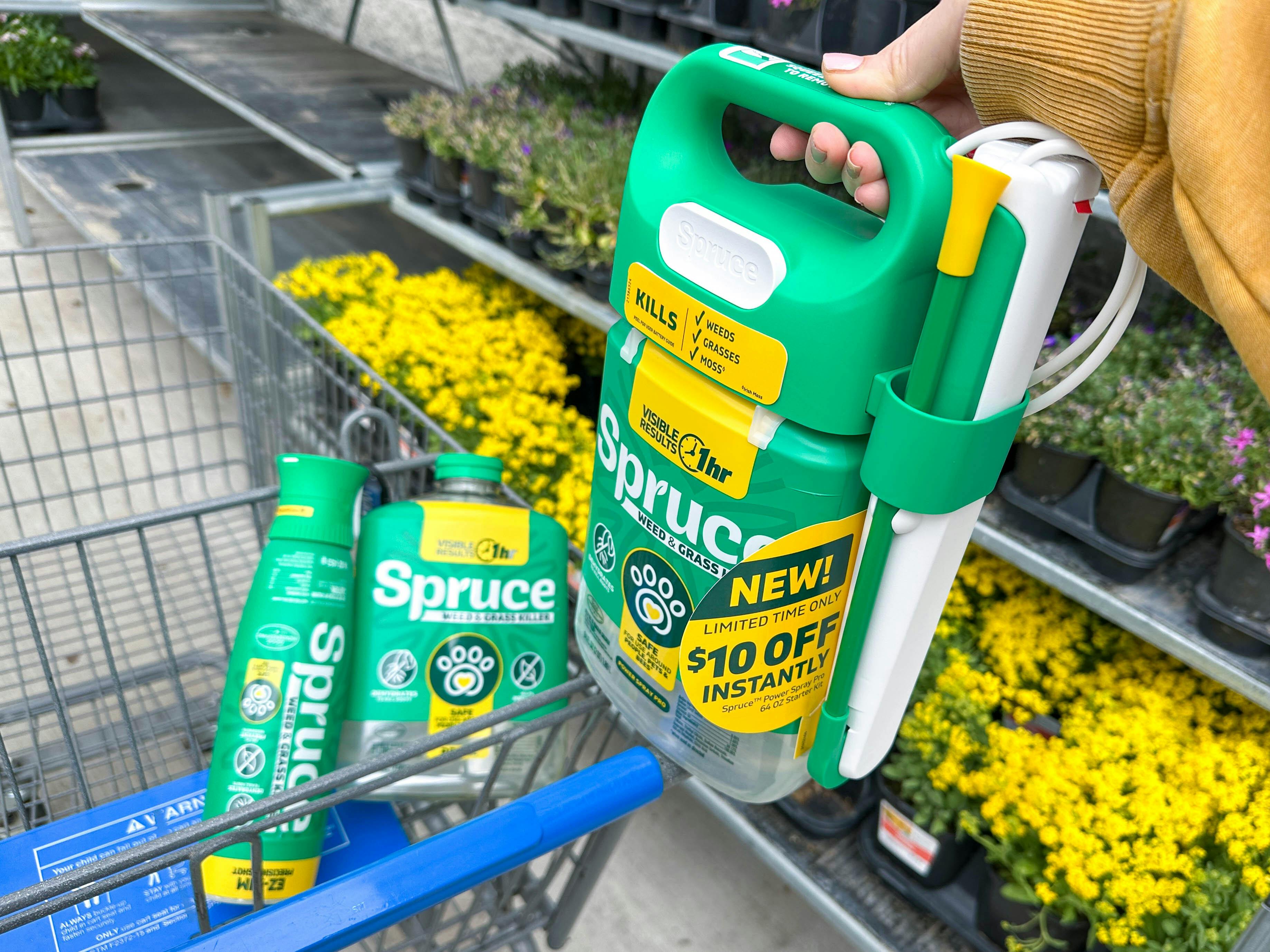 hand holding bottle of spruce weed and grass killer on walmart cart