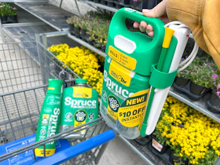 hand holding bottle of spruce weed and grass killer on walmart cart