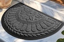 a rubber doormat in front of a home
