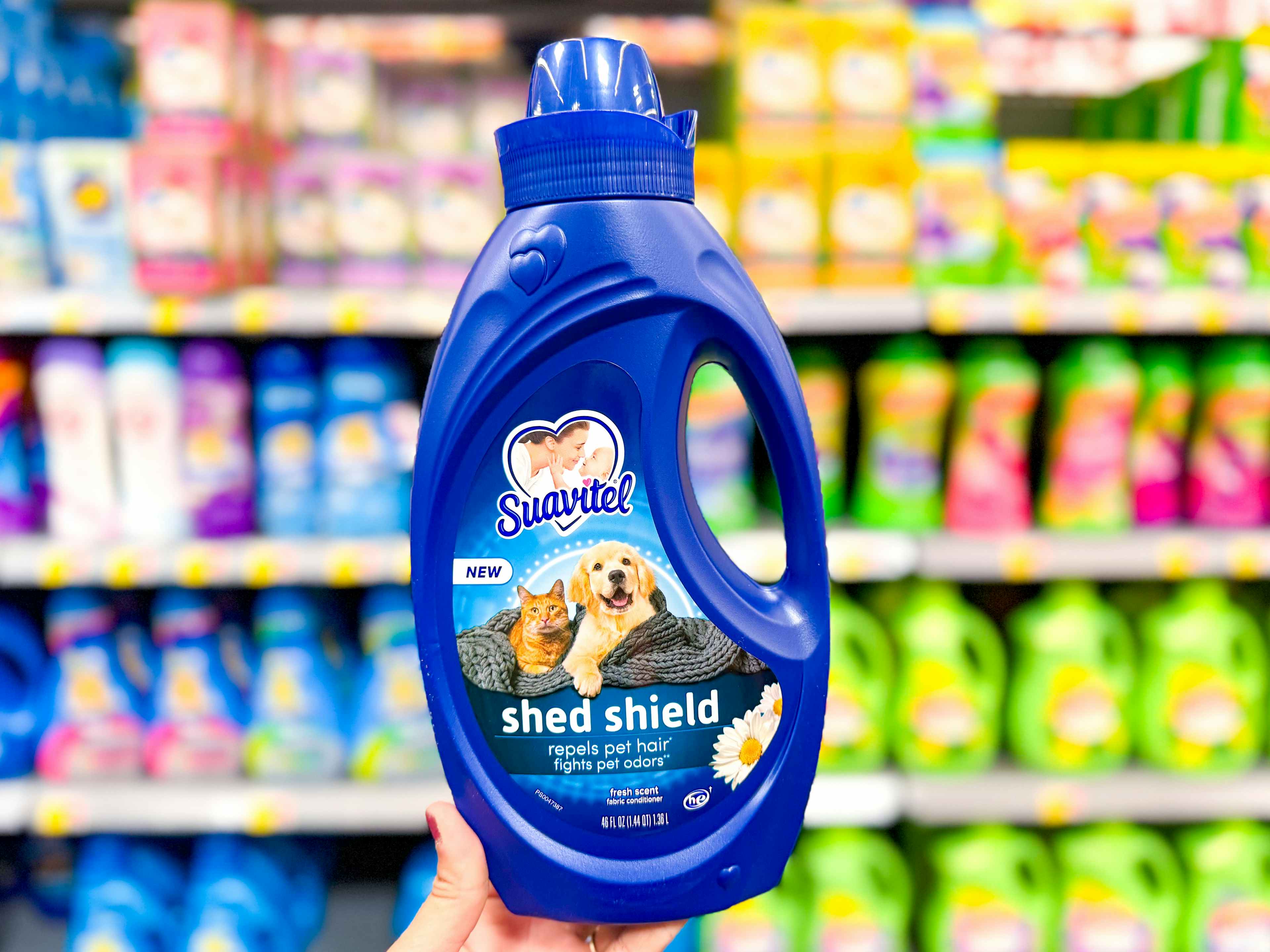 hand holding suavitel shed shield fabric conditioner at walmart