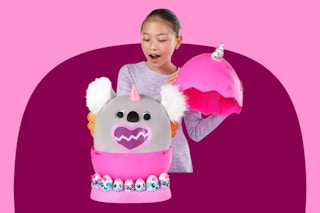 Rainbocorns Eggzania Toy: Stock image of child opening the toy to reveal a Koala inside