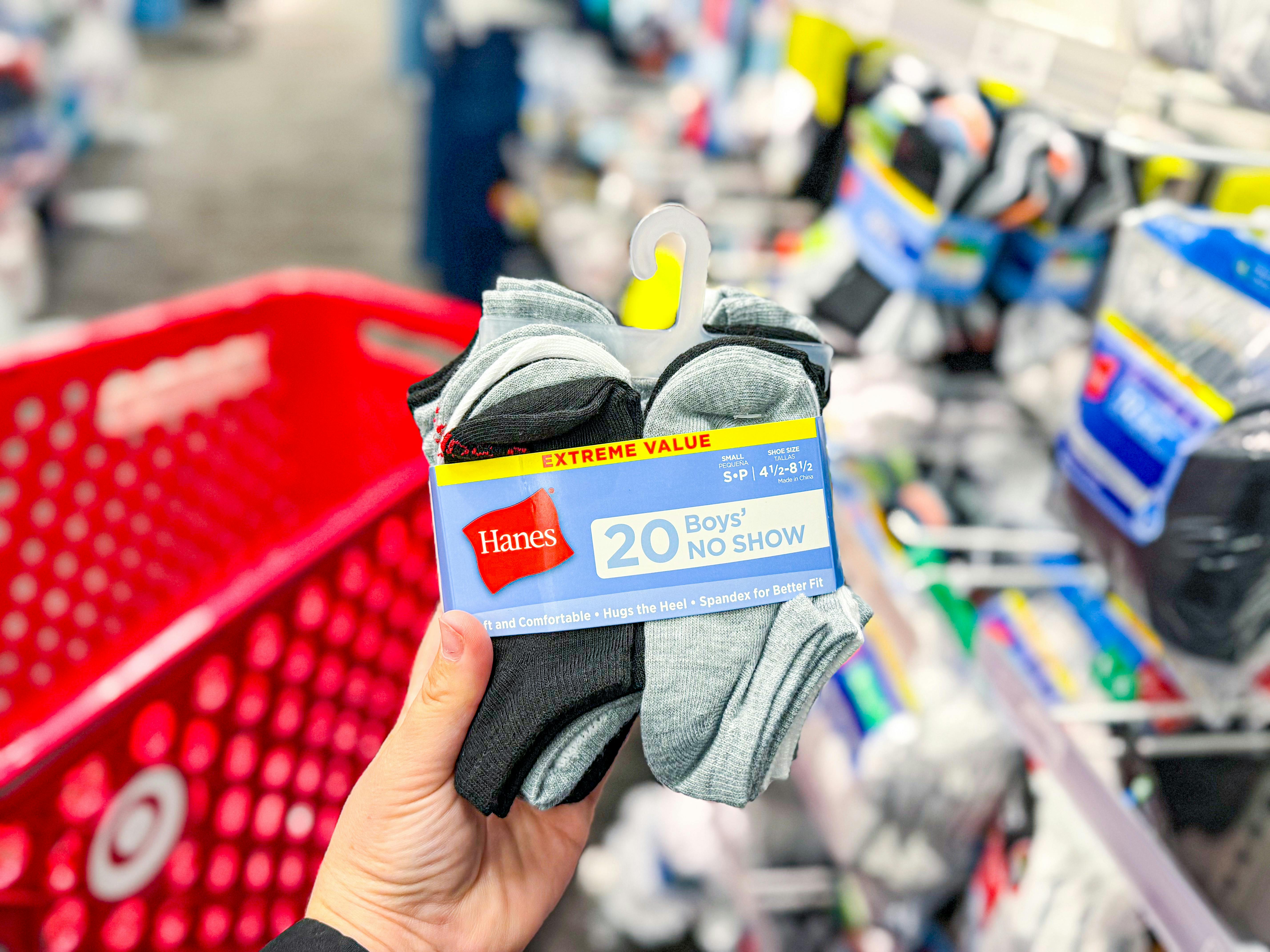 hand holding a pack of hanes kids socks at target