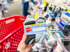 hand holding a pack of hanes kids socks at target