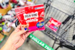 hand holding up a bag of milk bone minis dog treats at dollar tree