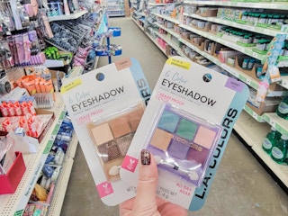 hand holding 2 eyeshadow palettes
