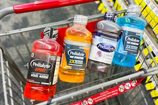 four bottles of pedialyte in a shopping cart