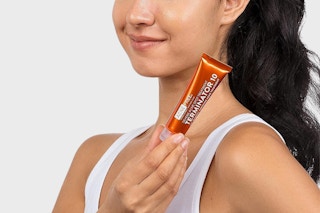 Person holding AcneFree Acne Treatment
