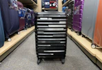 a spinner luggage in the middle of a store's aisle 