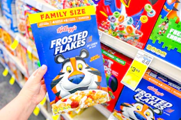 person holding a box of frosted flakes cereal