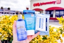 hand holding neutrogena cleansers and wipes outside of a cvs store