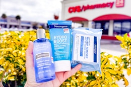 hand holding neutrogena cleansers and wipes outside of a cvs store
