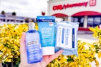 hand holding neutrogena cleansers and wipes outside of a cvs store