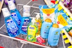 crest mouthwash, softsoap hand soap, nivea lip balm, ogx shampoo, and burts bees sheet masks in a cart